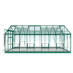 A green Rhino Greenhouse structure stands empty, featuring glass panels and a pitched roof. It is supported by a green metal frame, set against a plain white background.