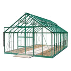 A green-framed glass Rhino Greenhouse stands on a paved base, with open sliding doors. It features roof vents, surrounded by a simple, empty setting suitable for gardening.