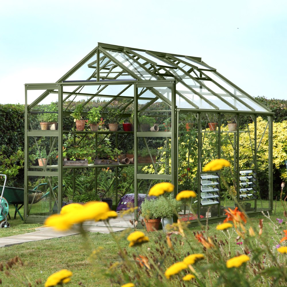 tuscan olive greenhouse in a well maintained garden setting