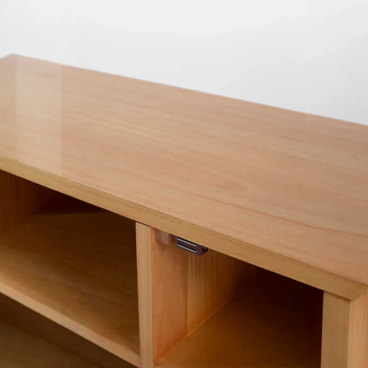 Wooden shelf with a metallic handle