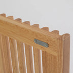 Wooden chair back with metal bracket on a light gray background